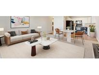 A comfortable living room with modern furniture and a stylish kitchen area in the background at 585 S Alton Way # 6B, Denver, CO 80247