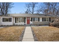Charming single-story home features a red front door and well-maintained landscaping at 4390 E Harvard Ave, Denver, CO 80222