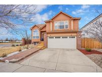 Charming two-story home with a two-car garage and well-maintained lawn in a quiet neighborhood at 14425 E 50Th Ave, Denver, CO 80239