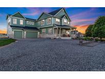 Charming two-story home with three-car garage, landscaped yard and a welcoming front porch at 881 Kirby Ct, Watkins, CO 80137