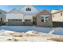 Two-story house with gray siding and a snow-covered front yard at 8791 Yellowcress St, Littleton, CO 80125