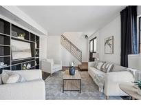 Bright living room with comfy seating and built-in shelving at 10360 E Jewell Ave # 95, Aurora, CO 80247