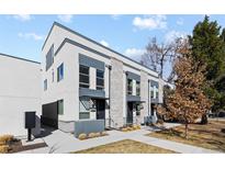 Modern townhouse exterior showcasing stylish architecture and well-maintained landscaping on a sunny day at 3875 E 4Th Ave # 2, Denver, CO 80206