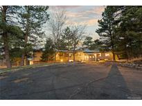 Inviting exterior view of a home with ample parking and lush trees at 7841 Deertrail Dr, Parker, CO 80138