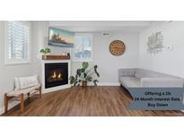 Bright living room features a cozy fireplace, stylish decor, and comfortable seating area at 760 W Asbury Ave, Denver, CO 80223