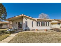 Charming single-story home featuring light siding, a covered porch, and well-maintained landscaping at 57 Scott S, Broomfield, CO 80020