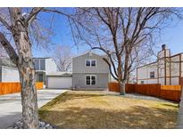 Charming two-story home featuring a well-maintained yard and an attached two-car garage at 1376 Urban St, Lakewood, CO 80401