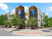 Contemporary condo exterior features mixed materials, balconies and lush, mature landscaping at 2335 Walnut St # 10, Denver, CO 80205