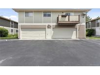 Exterior of condo with garages, balconies, and well-maintained landscaping at 6650 E Arizona Ave # 203, Denver, CO 80224