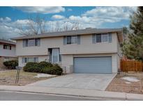 Ranch style home with attached garage and landscaped yard at 12866 E Ohio Ave, Aurora, CO 80012