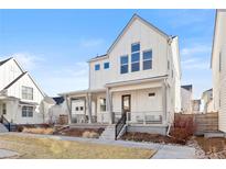Charming two-story home features a welcoming front porch and well-maintained landscaping at 5984 Fulton St, Denver, CO 80238
