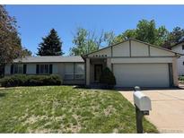 Charming single Gathering home with a well-manicured lawn and a two-car garage at 16180 E Flora Pl, Aurora, CO 80013