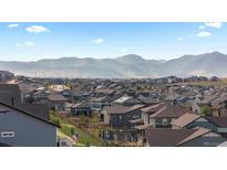 Picturesque neighborhood view with rolling hills and mountain backdrop at 17213 W 93Rd Pl, Arvada, CO 80007