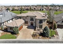 Stunning two-story home with a tile roof, well-manicured landscaping, and an attached two-car garage at 9099 E Harvard Ave, Denver, CO 80231
