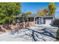 Charming single-story home featuring a well-maintained yard, garage, and inviting curb appeal at 930 S Eliot St, Denver, CO 80219