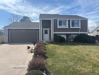 Charming two-story home with a well-maintained front yard and an attached two-car garage at 5971 S Tabor St, Littleton, CO 80127