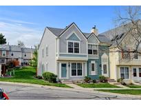 Charming townhome featuring two-story facade with landscaped yard and colorful exterior finishes at 9188 W Ontario Dr, Littleton, CO 80128