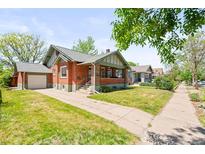 Charming brick home with a well-maintained front yard and inviting curb appeal in a desirable neighborhood at 4945 Perry St, Denver, CO 80212