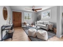 Bright living room features hardwood floors, a ceiling fan, and modern decor at 610 E Baseline Rd, Lafayette, CO 80026