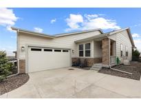 Charming single-Gathering home with a two-car garage, covered porch, and meticulous landscaping at 2020 Sagerock Dr, Castle Pines, CO 80108