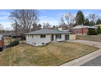 Charming single-story home with a well-maintained front yard and an attached garage at 2765 S Winona Ct, Denver, CO 80236