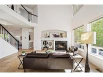 Bright living room boasts a fireplace, high ceilings, large windows, and an open floor plan at 4340 Nelson Dr, Broomfield, CO 80023