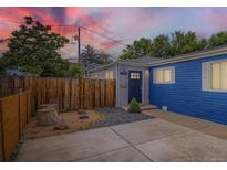 Charming home featuring a blue exterior, welcoming entrance, and modern landscaping with a wooden fence at 1021 Stuart St, Denver, CO 80204