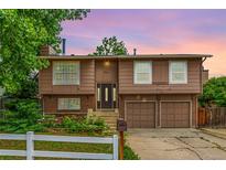 Charming split level home featuring a two car garage, and a well-maintained yard at 9832 High St, Thornton, CO 80229