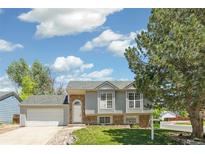 Charming two-story home featuring stone accents, updated windows, and a well-maintained lawn at 5886 S Nepal Way, Centennial, CO 80015