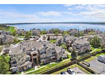 Scenic aerial view of lakeside townhomes, green lawns and water at 4760 S Wadsworth Blvd # K205, Littleton, CO 80123