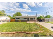 Charming home with a well-manicured lawn and inviting curb appeal on a sunny day at 2630 W Asbury Ave, Denver, CO 80219