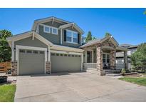 Beautiful two-story home features a three-car garage and a charming front porch with stone pillars at 15562 E 109Th Ave, Commerce City, CO 80022