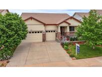 Charming single Gathering home showcasing a three-car garage, beautiful landscaping, and inviting front porch at 6618 Lynch Ln, Castle Rock, CO 80108