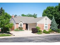 Charming single-story home with well-maintained landscaping, brick accents, and an attached two-car garage at 5351 S Cody St, Littleton, CO 80123