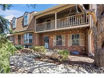 Charming brick townhome with a cozy balcony and beautifully landscaped front yard at 7101 W Yale Ave # 3403, Denver, CO 80227