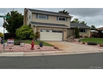 Charming two-story home boasts a well-maintained yard, complemented by tasteful landscaping and a convenient two-car garage at 13266 Canopus Dr, Lone Tree, CO 80124