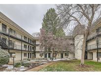 Charming apartment complex courtyard featuring landscaped grounds and mature trees with walkways at 5875 E Iliff Ave # 115, Denver, CO 80222