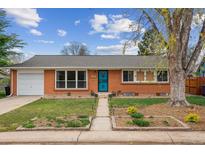 Charming brick home with mature tree, lawn and garden beds at 5481 E Tennessee Ave, Denver, CO 80246