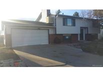 Two-story home with a brick and vinyl facade and an attached two-car garage at 757 Norfolk Way, Aurora, CO 80011