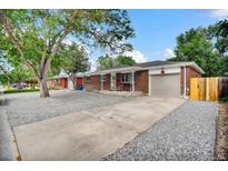 Charming brick home featuring a well-maintained front yard and a convenient attached garage at 61 S 17Th Avdr, Brighton, CO 80601