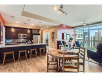 Open-concept living space with modern kitchen, dining area, and balcony access at 2001 Lincoln St # 2213, Denver, CO 80202