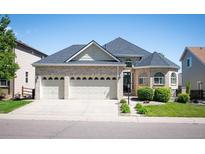 Lovely two-story home with a three car garage and manicured front yard at 7007 S Garrison St, Littleton, CO 80128