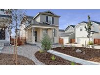 Charming two-story home featuring a stone facade, covered porch, and xeriscaped front yard at 3365 N Coolidge Way, Aurora, CO 80019