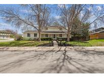 Charming two-story home with mature trees and well-manicured front yard, perfect curb appeal at 3756 S Chase St, Denver, CO 80235