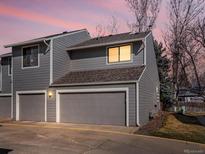 Gray two-story townhouse featuring an attached one-car garage, creating an inviting curb appeal at 277 S Taft Ct # 54, Louisville, CO 80027