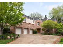 Charming brick home with a three-car garage and mature trees, offering curb appeal and convenience at 6274 S Iola Ct, Englewood, CO 80111