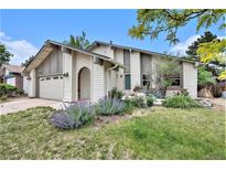 Charming home with landscaped front yard, inviting entryway, and attached garage at 3756 S Mission Pkwy, Aurora, CO 80013