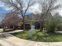 Inviting two-story home featuring a two-car garage and well-maintained landscaping at 14944 E Archer Cir, Aurora, CO 80012