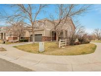 A well-kept front yard with a two-story house featuring a two-car garage and classic design at 14944 E Archer Cir, Aurora, CO 80012