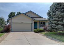 Charming single Gathering home featuring a two-car garage and a well-maintained lawn at 9784 W Euclid Dr, Littleton, CO 80123